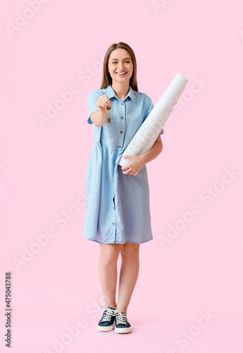 Smiling young woman with ke...