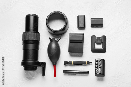 Photo equipment on light table background, top view