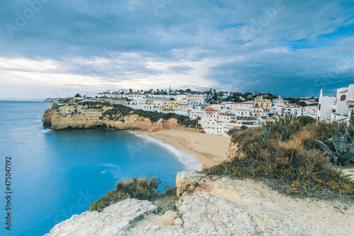 Stormy sky above village and sandy beach, Carvoeiro, Algarve, Portugal, Europe