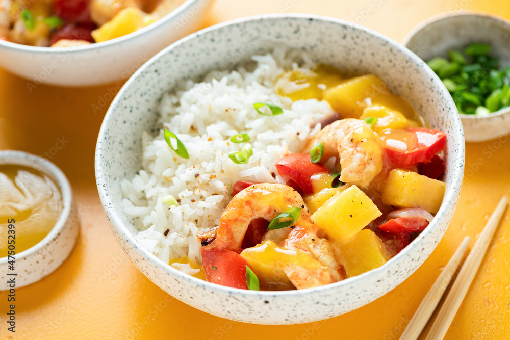 Rice with shrimp pineapple curry in a bowl, closeup view, yellow background Rice with shrimp pineapple curry in a bowl, closeup view, yellow background