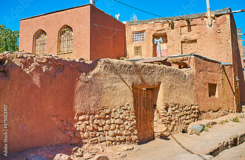 The medieval living house with modern extension and old stone-adobe fence, Abyaneh, Iran. photo