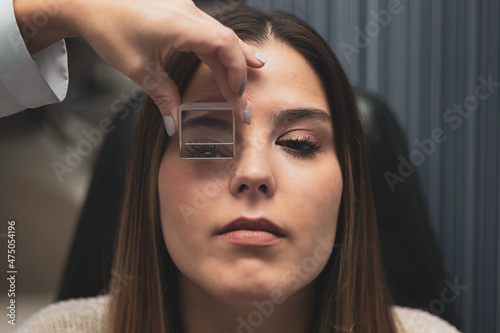 a girl is subjected to a prism for optometrists to analyze fusional vergences.