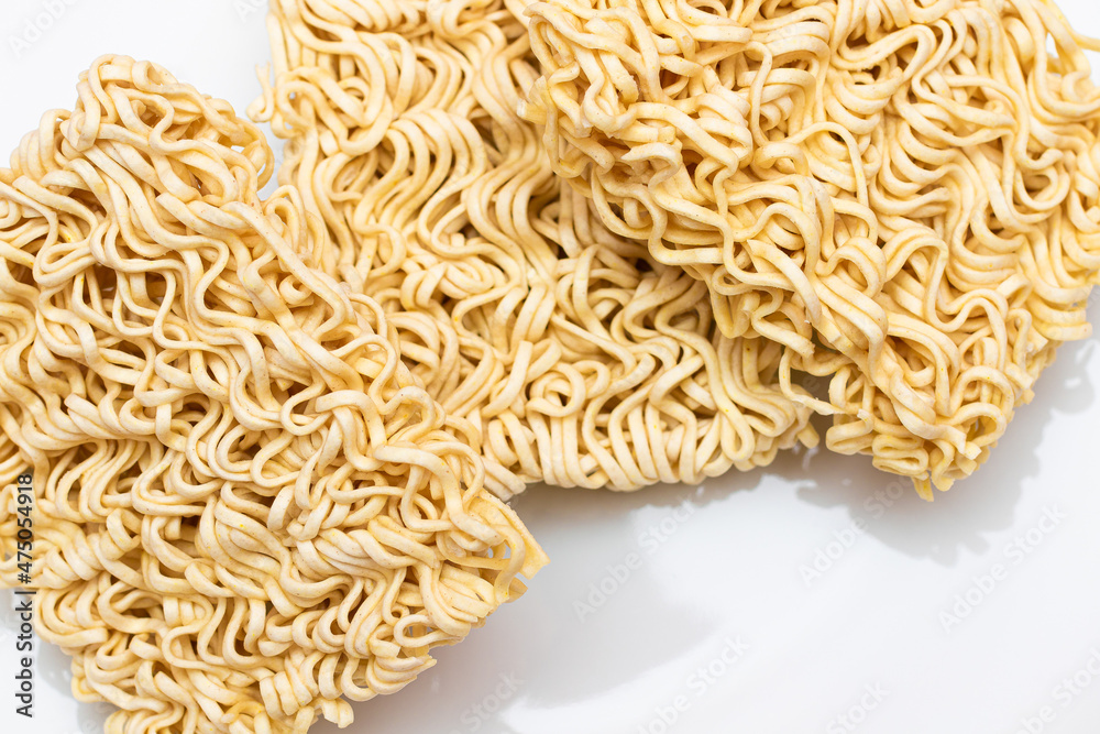 Uncooked Instant Noodles on White Plate. Raw Pasta. Dry Asian Fast Food. Quick Lunch Uncooked Instant Noodles on White Plate. Raw Pasta. Dry Asian Fast Food. Quick Lunch