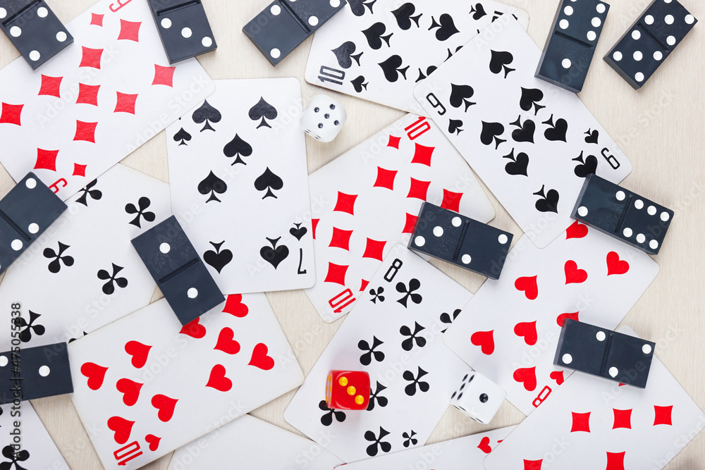 Playing cards, dominoes and dice for board games on light table. View from above. Playing cards, dominoes and dice for board games on light table. View from above.