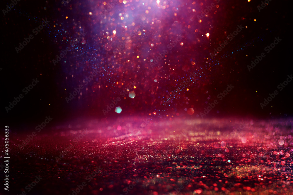background of abstract red, purple, gold and black glitter lights. defocused