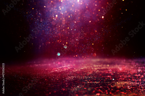 background of abstract red, purple, gold and black glitter lights. defocused
