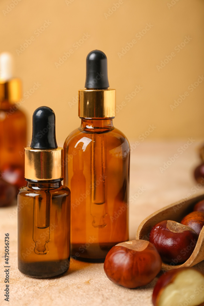 Bottles of chestnut essential oil on table, closeup Bottles of chestnut essential oil on table, closeup