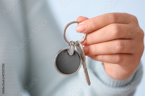 Woman holding key on chain, closeup