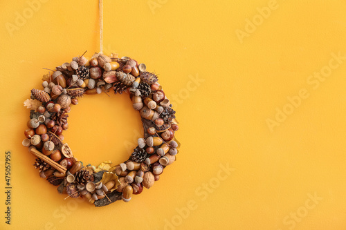 Beautiful acorn wreath on orange wall