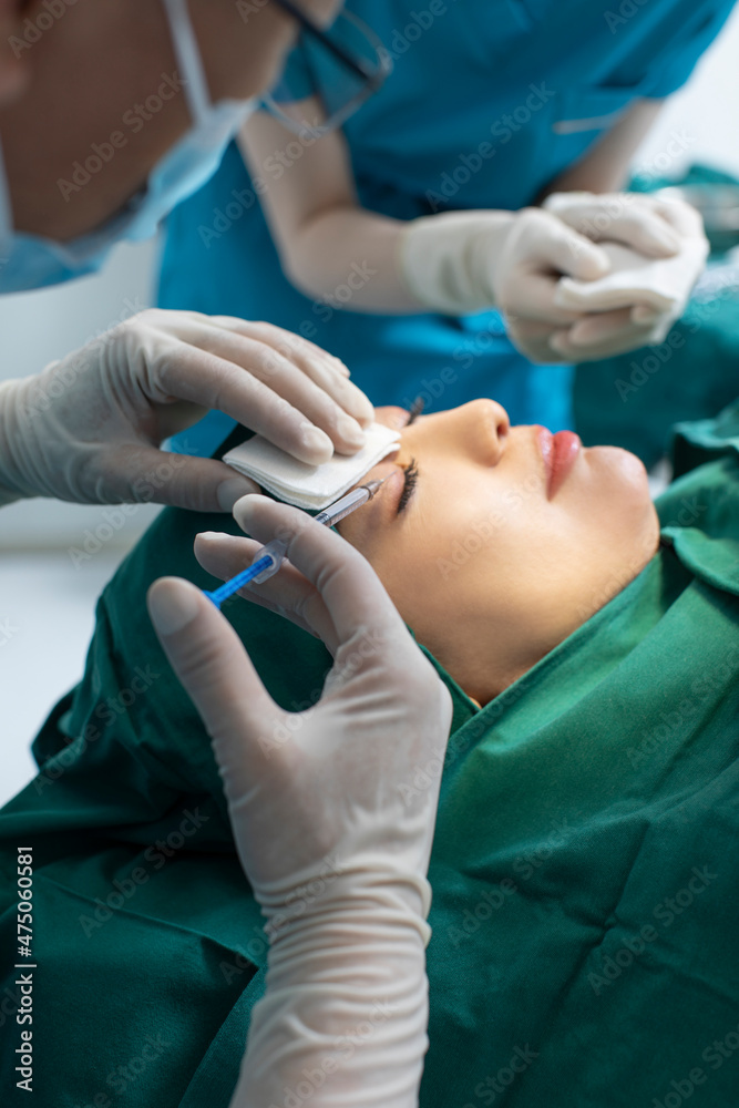 Mid adult woman receiving facial plastic surgery Mid adult woman receiving facial plastic surgery