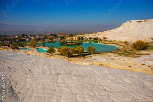 PAMUKKALE, TURKEY: Landscape with a view of a pond in a Natural Park and white travertine on a sunny day in Pamukkale.