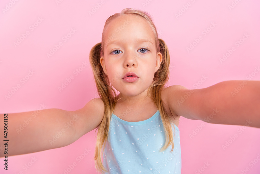 Self-portrait of attractive cute candid blond girl spending free time isolated over pink pastel color background Self-portrait of attractive cute candid blond girl spending free time isolated over pink pastel color background