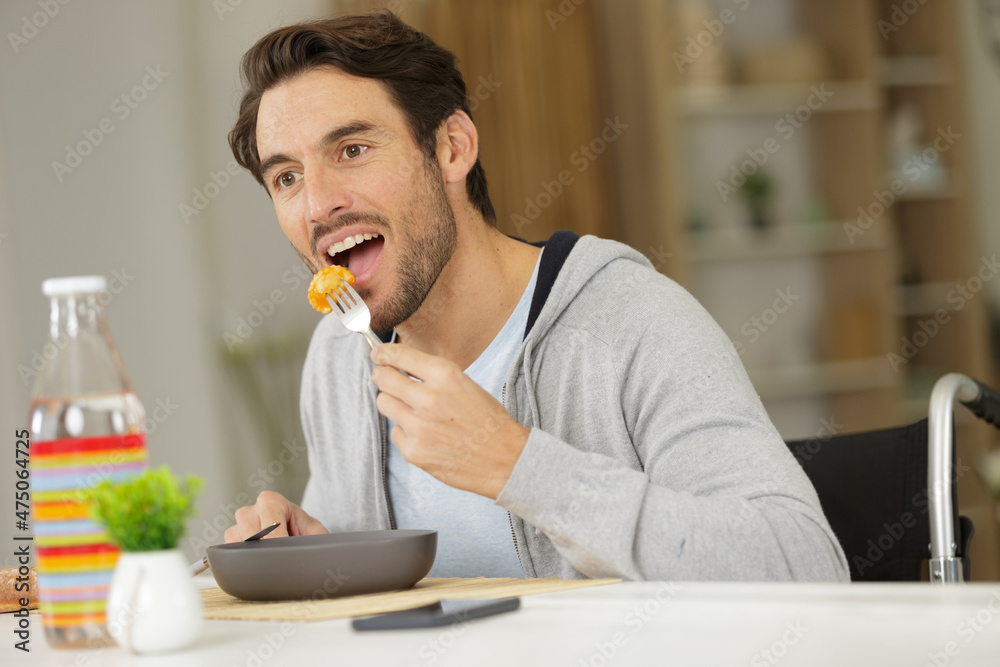 disabled young man having lunch disabled young man having lunch