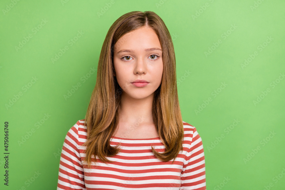 Obraz premium Photo of calm young teenager charming blonde lady look camera wear striped shirt isolated green color background