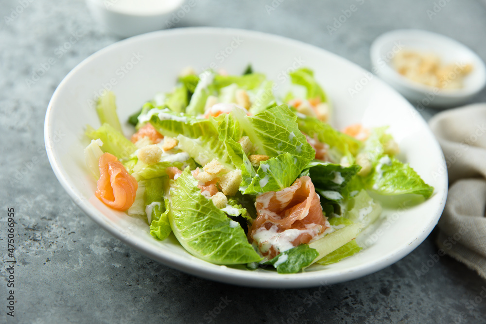 Traditional homemade Caesar salad with smoked salmon Traditional homemade Caesar salad with smoked salmon