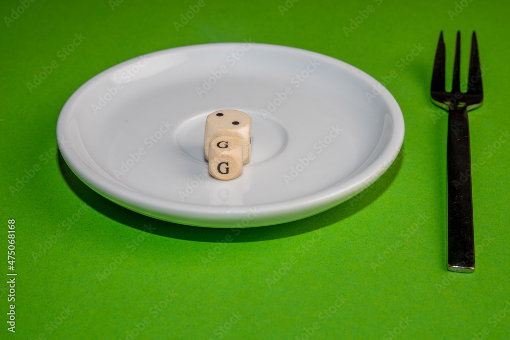 Concept Image for 2G control, white cubes form 2G on a withe plate against a green background Concept Image for 2G control, white cubes form 2G on a withe plate against a green background