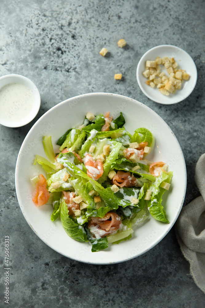 Traditional homemade Caesar salad with smoked salmon Traditional homemade Caesar salad with smoked salmon