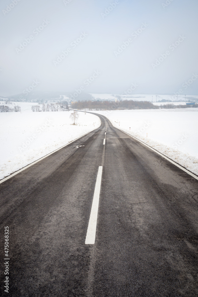Fototapeta premium Country road in snowy winter day