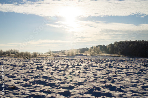 Beautiful empty landscape of winter steppe field. Snowy sunny cold day