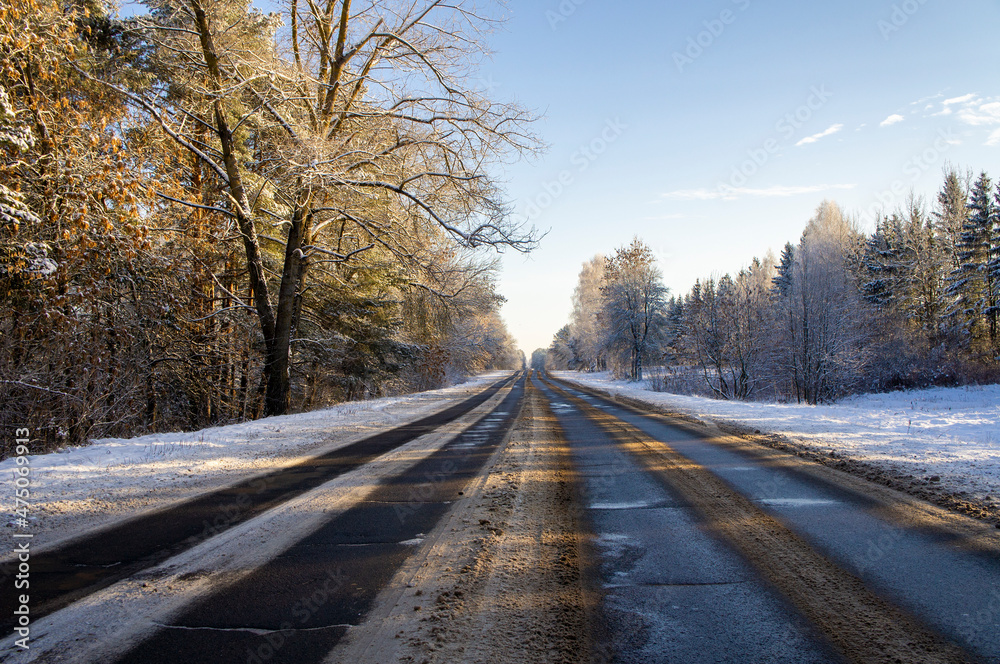 Beautiful empty winter snow road on a sunny cold day Beautiful empty winter snow road on a sunny cold day