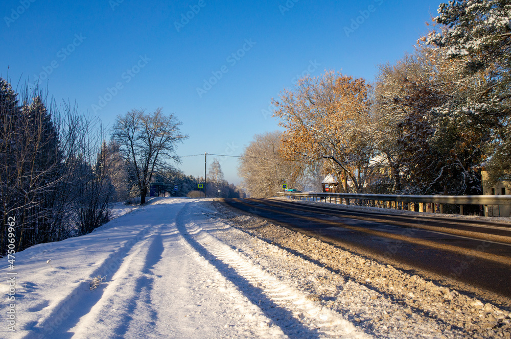 Beautiful empty winter snow road on a sunny cold day Beautiful empty winter snow road on a sunny cold day
