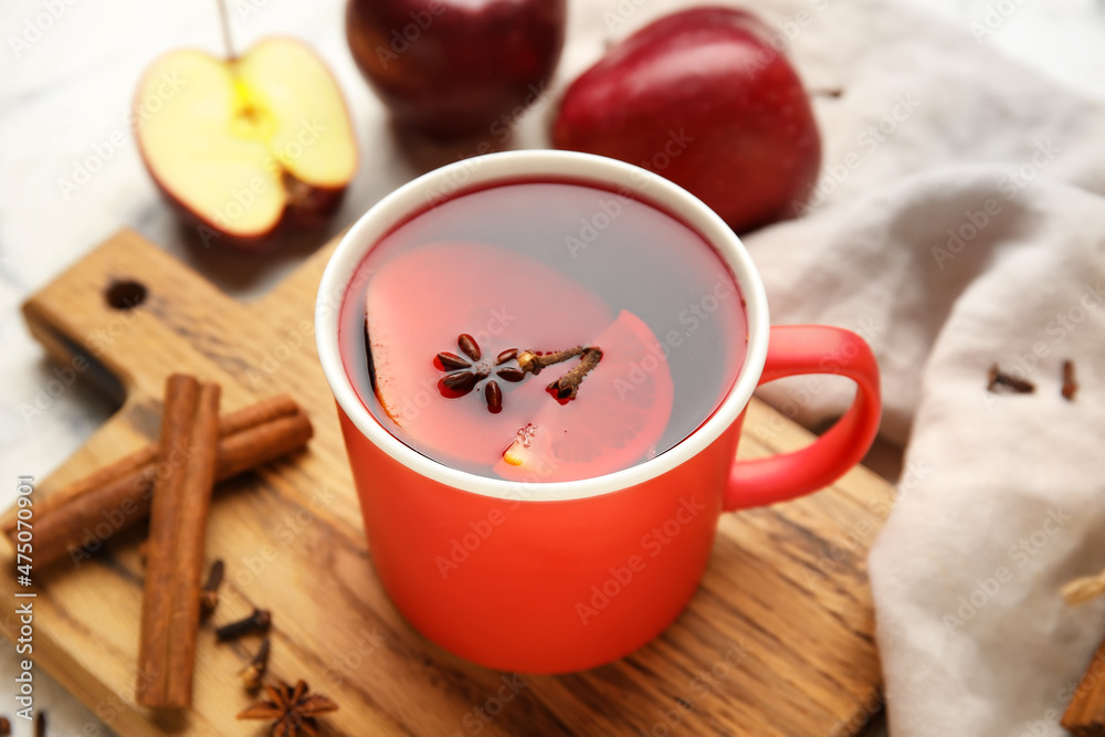 Cup of tasty fruit tea with cinnamon on table