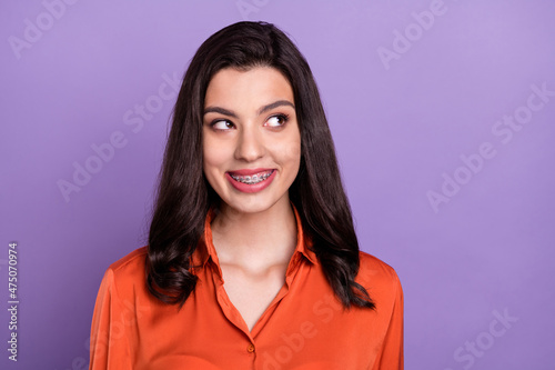 Portrait of attractive cheerful curious girl thinking copy space isolated over bright purple violet color background