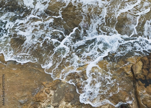 sea water with foam on the rocky coast