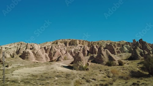 Fairy chimneys side view on a sunny day in Cappadocia, Turkey. 