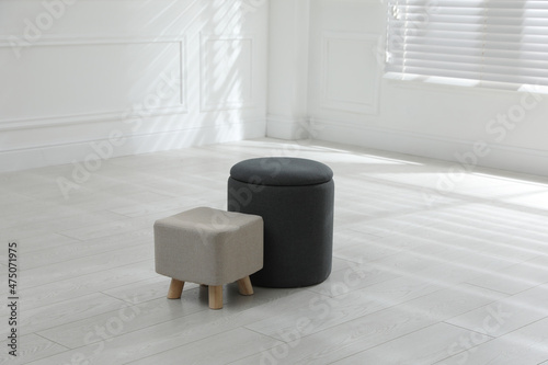 Different stylish ottomans in room. Home design