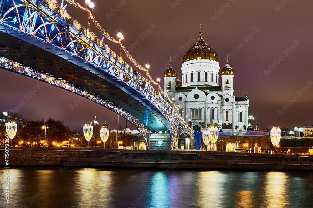 Christmas Moscow. Kremlin and embankment in capital of Russia. New Year's decorations on Moscow embankment. Russian city in Christmas illumination. Moscow river on a winter night