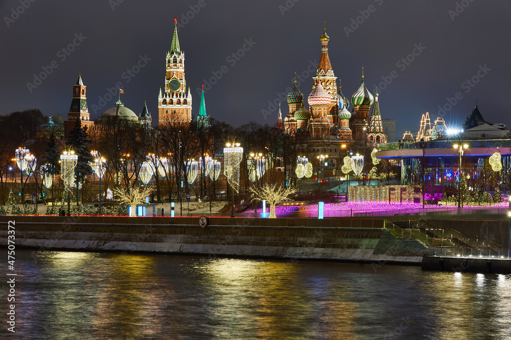 Christmas Moscow. Kremlin and embankment in capital of Russia. New Year's decorations on Moscow embankment. Russian city in Christmas illumination. Moscow river on a winter night
