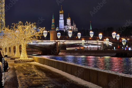 Christmas Moscow. Kremlin and embankment in capital of Russia. New Year's decorations on Moscow embankment. Russian city in Christmas illumination. Moscow river on a winter night photo