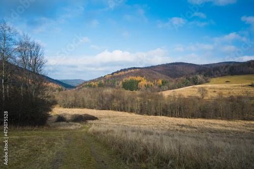 low Beskid in autumn  mountains panorama sunny weather  mountains trees clouds blue sky  end of summer in the mountains  fog mountain tourism  walk in the mountains