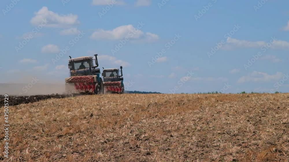 plowing with a tractor with a plow in the field plowing with a tractor with a plow in the field