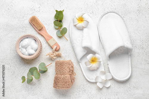 Composition with bath supplies for massage and slippers on light background
