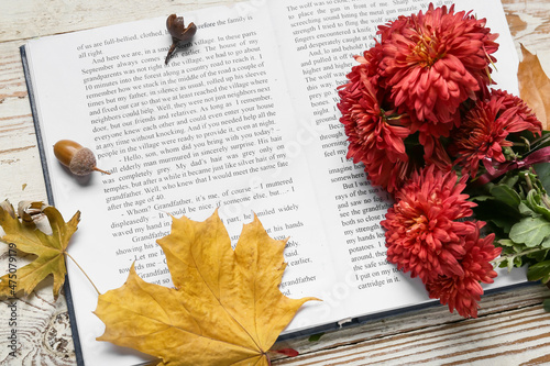 Open book, autumn leaves an...
