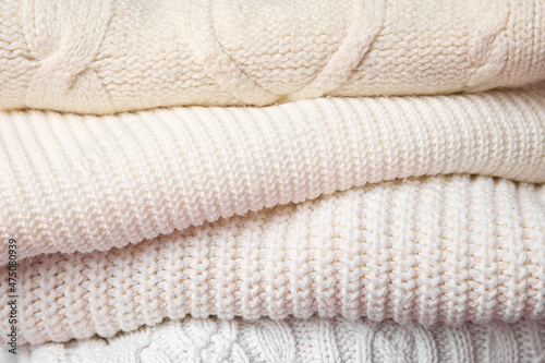 Stack of knitted sweaters, closeup