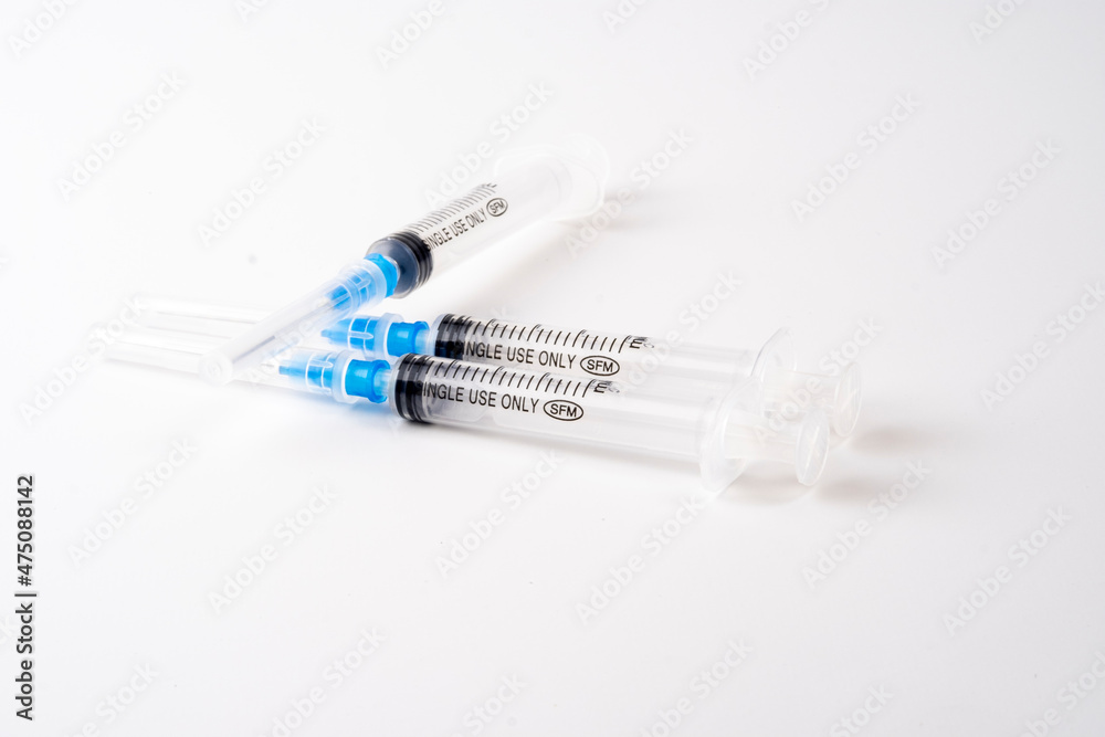 medical syringe isolated on white background with blue needle medical syringe isolated on white background with blue needle