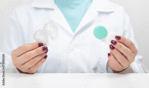 Different types of Contact Lenses. Doctor Ophthalmologist holding in hands one-day contact lenses and reusable contact lenses. Myopia and eyesight problem