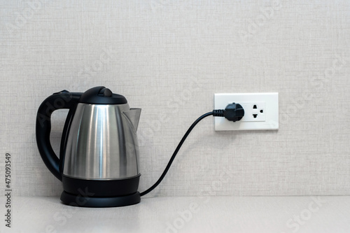 Canvastavla Silver metal electric kettle for boiling water and making tea on a table