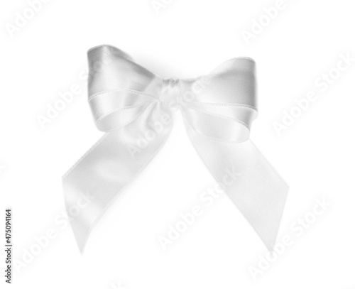 Satin ribbon tied in bow on white background, top view