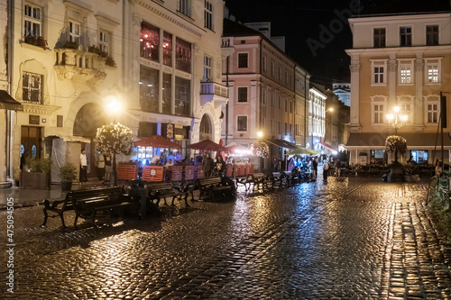 Night rainy view to the Rynok or Market Square in Lviv, Ukraine. October 2021