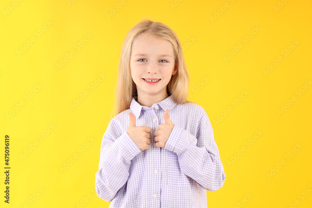 Cute little girl in shirt on yellow background Cute little girl in shirt on yellow background