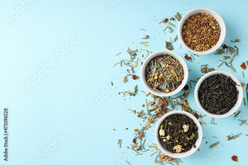 Concept of cooking tea with different types of tea on blue background