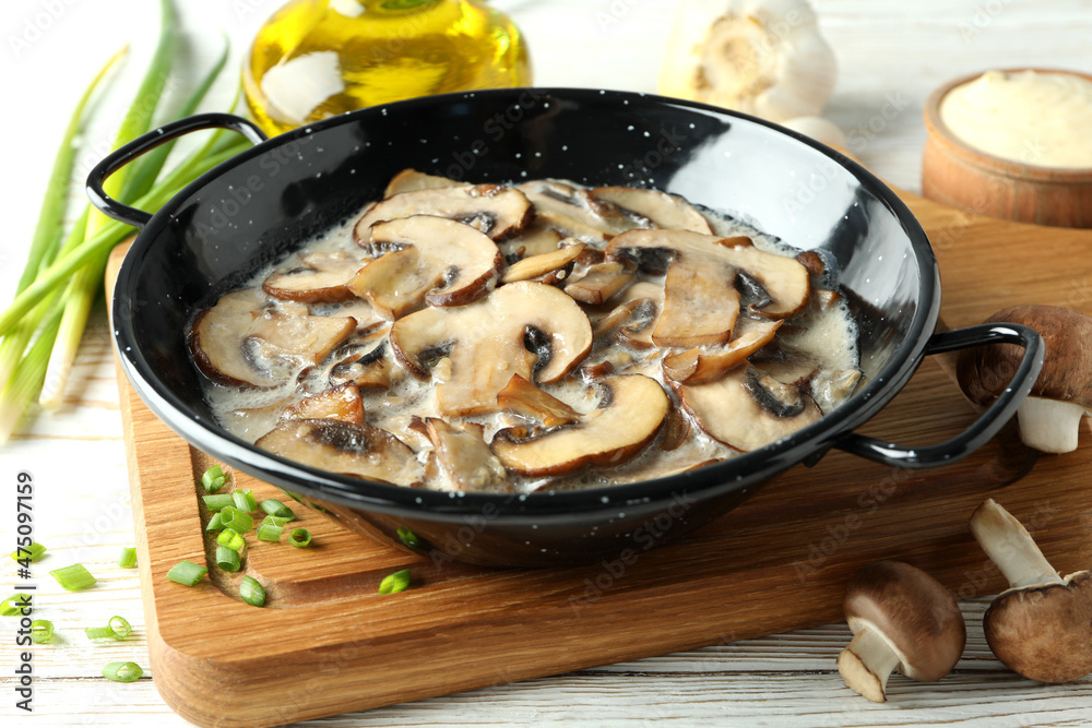 Concept of tasty food with mushroom sauce on white wooden background Concept of tasty food with mushroom sauce on white wooden background