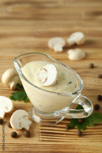 Concept of tasty food with mushroom sauce on wooden background