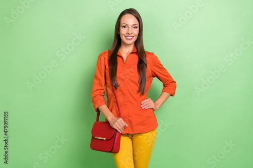 Photo of mature adorable woman good mood wear casual clothes trip isolated over green color background
