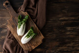 Leafy cabbage bok choy on a cutting board, healthy green vegetables.