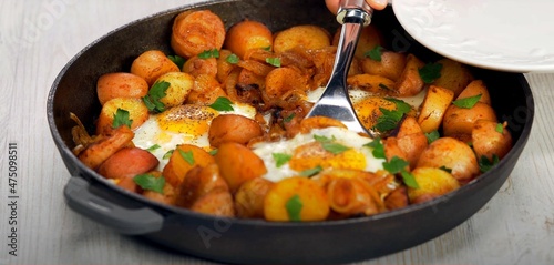 fried eggs with fried potatoes and onions